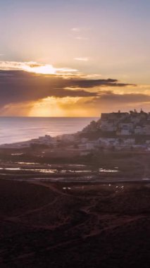 Vertical video of Sunset evening sky over small city in Morocco ocean coast, Time lapse landscape ideal for Social media stories
