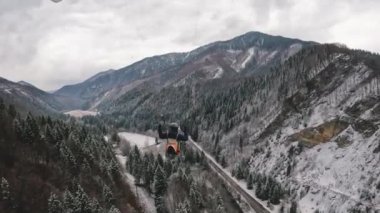 Karlı dağların üzerinde paragliding uçuş doğa ve orman yolu soğuk bulutlu doğa, ekstrem spor takip kamera, yavaş çekim 4k