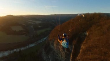 Paragliding Freedom akşam doğasında altın gün batımında uçuyor. Adrenalin macera uçuşu.