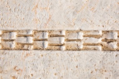 Eski bir geçmiş. Antik Yunan tarzı, kıvırcık mimari unsur, tekrarlayan desen. Kireçtaşı.