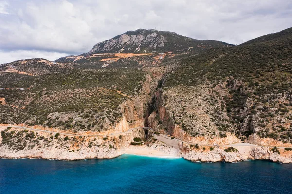 stock image Aerial view of a beautiful bay with a beach and turquoise sea among big mountains. Kaputas beach, Kas, Trkiye.