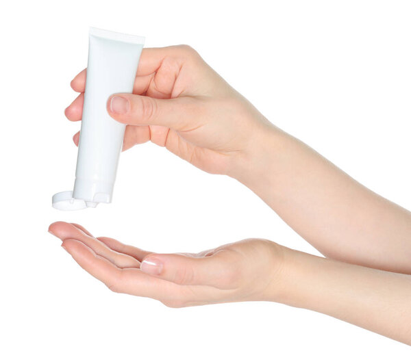 Woman hands squeezing a white cosmetic cream tube, on a white background close-up, template for cosmetics ads