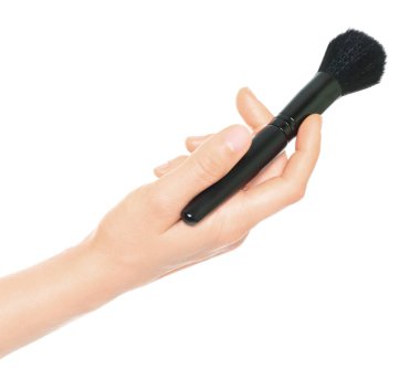 Woman hand holds black cosmetics brush, isolated on a transparent background, cosmetics and visage concept