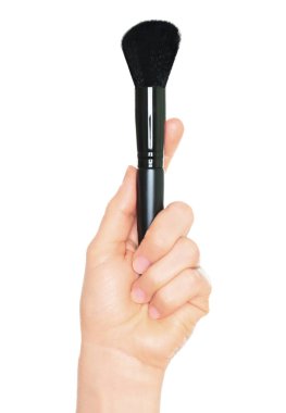 Woman hand holds black cosmetics brush, isolated on a transparent background, cosmetics and visage concept