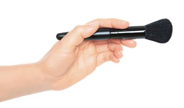 Woman hand holds black cosmetics brush, isolated on a transparent background, cosmetics and visage concept