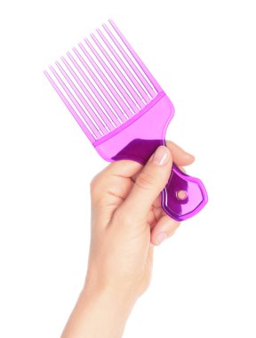 Woman hand holds comb, isolated on a transparent background, visage concept