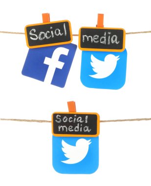 Set of Facebook and Twitter paper icons, which hanging on a rope with tag orange clothespins with chalk written Social Media words, isolated on a transparent background