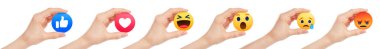 Set of Hands, which holding paper Facebook Empathetic Emoji Reactions, isolated on a transparent background