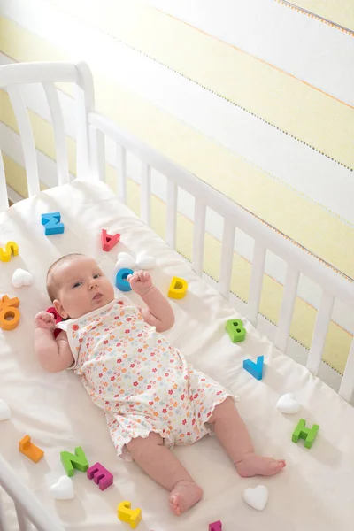 Baby Girl Baby Bed Wooden Letters Aroud Baby Stock Image