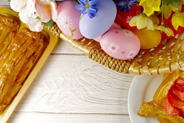 flat lay of  easter eggs  and cakes on white background. easter concept. 