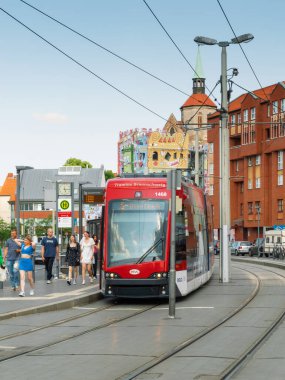 Braunschweig, Brunswick, Almanya - Haziran 09, 2023. İnsanlar Braunschweig caddesinde kırmızı tramvaydan iniyorlar. İş gününün sonunda. Yaşam tarzı, sokak fotoğrafçılığı