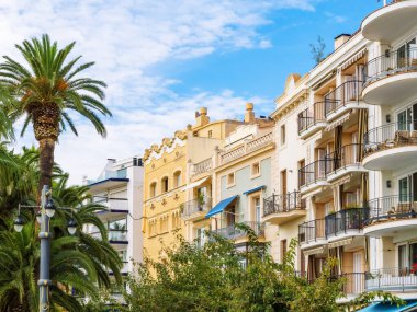 Turistik bir şehirde güzel mimari, konut binaları ve palmiye ağaçları Sitges, Katalonya, İspanya, şehir hayatı.
