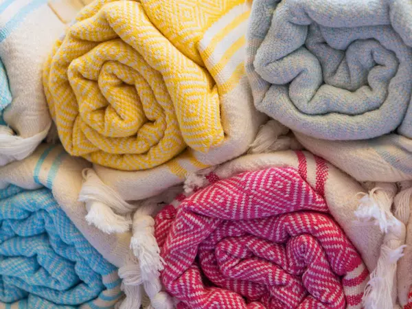 Close-up of twisted colored towels, textiles, bedspreads, sauna towels, fabrics, home textiles, organic cotton products..