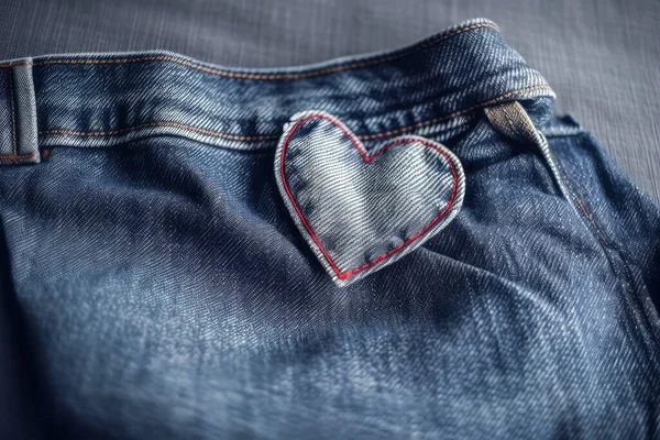 Jeans with a heart-shaped embroidery on the fabric