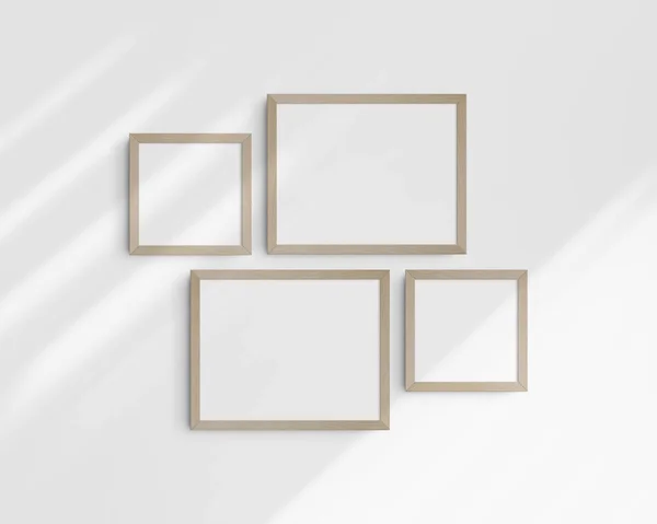 Gallery wall mockup set, 4 birch wooden frames. Clean, modern, and minimalist frame mockup. Two horizontal frames and two square frames, 14x11 (14:11), 8x8 (1:1) inches, on a white wall with shadows.