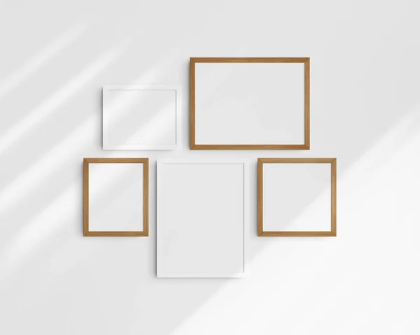 Gallery wall mockup set, 5 white and cherry wood frames. Modern frame mockup. Two horizontal frames, two vertical frames, and a square frame, 12x16 (3:4), 16x12 (4:3), 8x10 (4:5), 10x8 (5:4), 10x10 (1:1) inches, on a white wall with shadows.