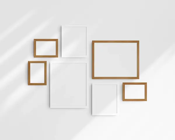 Gallery wall mockup set, 7 white and cherry wood frames. Clean, modern, and minimalist frame mockup. Three horizontal frames, and four vertical frames, 5x7 (5:7), 7x5 (7:5), 8x10 (4:5), 12x15 (4:5), 15x12 (5:4) inches, on a white wall with shadows.