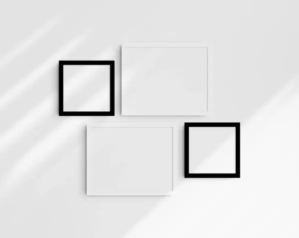 画廊壁面造型 4个黑白相框 简约的框架模型 两个水平框架和两个正方形框架 14X11 8X8 在有阴影的白墙上 免版税图库图片