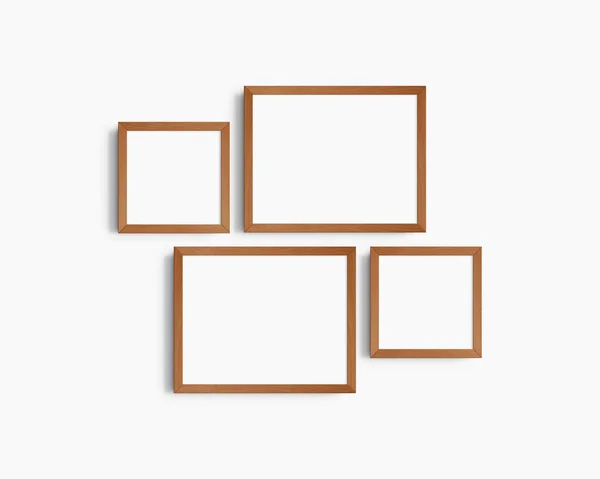 画廊壁面造型 4个樱桃木框架 简约的框架模型 白色墙壁上的两个水平框架和两个正方形框架 14X11 8X8 免版税图库图片