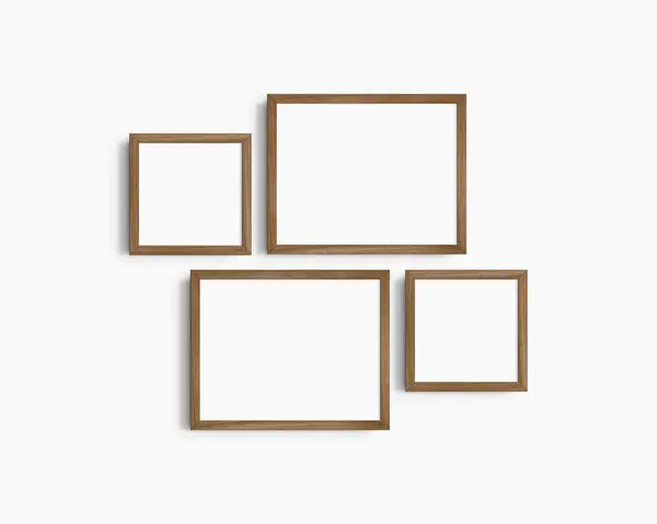画廊壁面造型 4个棕色核桃木框架 简约的框架模型 白色墙壁上的两个水平框架和两个正方形框架 14X11 8X8 免版税图库照片