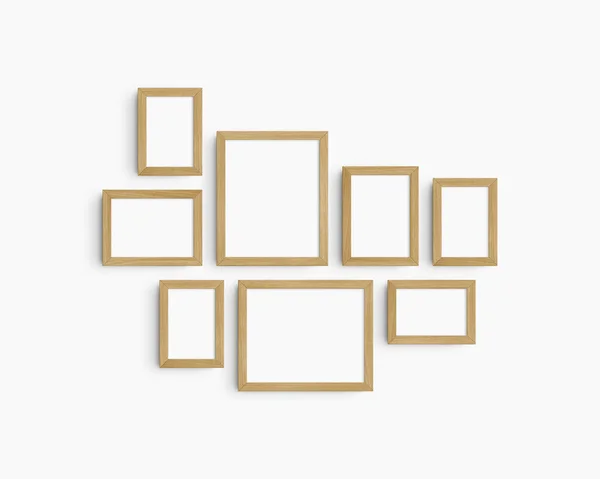 画廊壁面造型 8个橡木木架 简约的框架模型 白墙上的5个垂直框架和3个水平框架 4X6 6X4 5X7 7X5 8X10 10X8 免版税图库照片