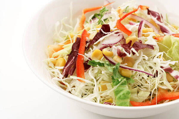 Shredded cabbage and colorful vegetable salad