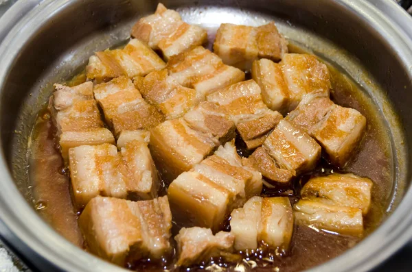 Boil the pork in a pot. Japanese food,Okinawa cuisine Rafuthy. Okinawan-style stewed pork cubes, pork belly, stewed in awamori, soy, dashi broth, and sugar.