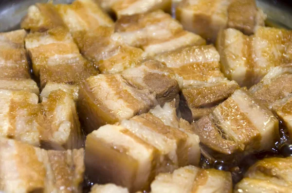 Boil the pork in a pot. Japanese food,Okinawa cuisine Rafuthy. Okinawan-style stewed pork cubes, pork belly, stewed in awamori, soy, dashi broth, and sugar.