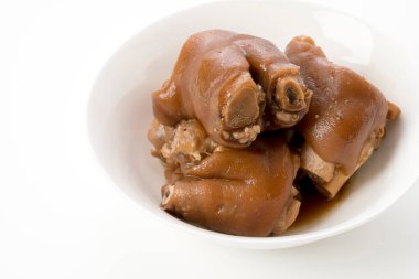 Stewed pork leg in white bowl on white background