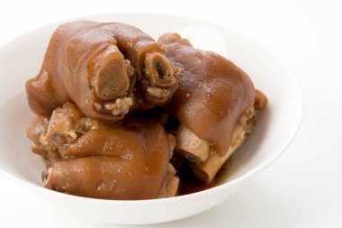 Stewed pork leg in white bowl on white background