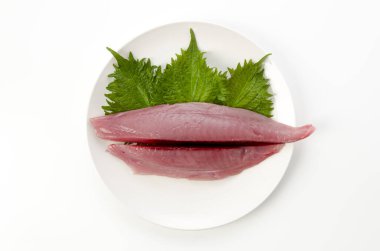 Beyaz arkaplanda tabakta sarı yüzgeçli ton balığı filetosu