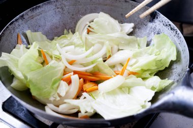 Stir-fried vegetables in a wok pan