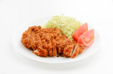 Chicken cutlet with shredded cabbage and tomato on plate on white background