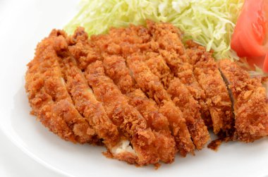 Chicken cutlet with shredded cabbage and tomato on plate on white background