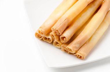 Cheese sticks on plate on white background