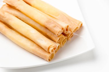 Cheese sticks on plate on white background