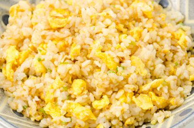 Homemade fried rice mixed with green onion and eggs