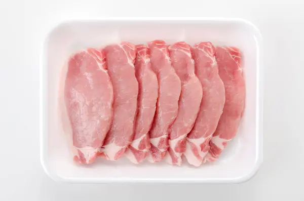Pork meat inside styrofoam tray in White background.