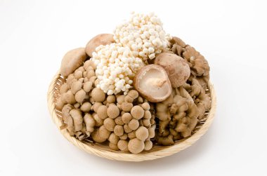 Mushrooms on a bamboo basket. Shimeji, buna-shimeji, Enoki, maitake, shiitake,  clipart