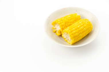 Beyaz arka planda kaynamış mısır.