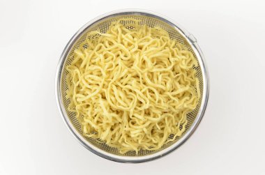 Okinawa soba noodles placed in a stanless steel colander for draining oil  on white background  clipart