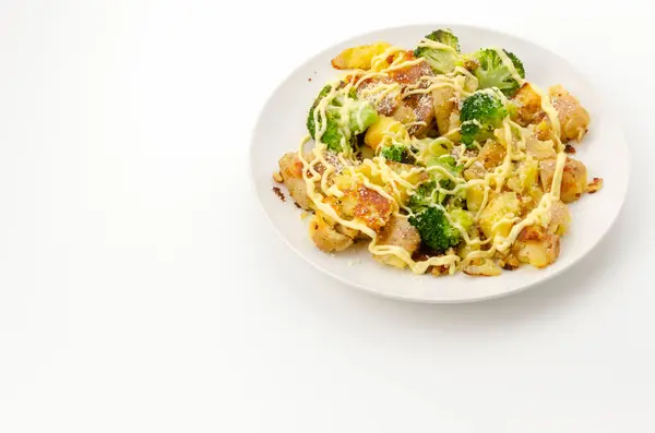 Stock image Baked potatoes and broccoli with mayonnaise dressing