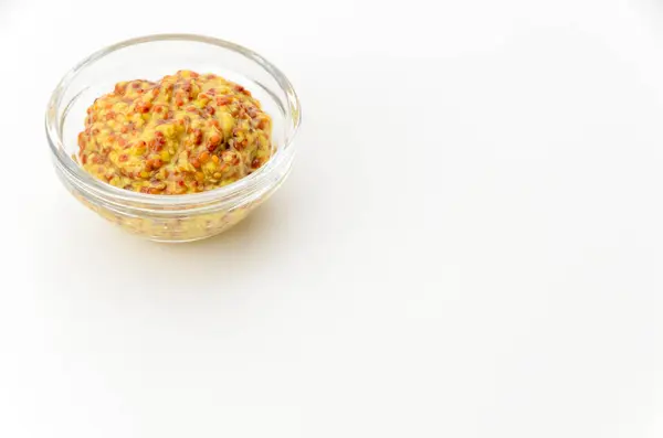 stock image whole grain mustard in small glass bowl on white background