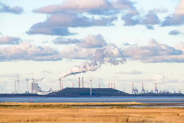 Industry, wind turbines and the coal-fired power station at the Maasvlakte, Port of Rotterdam, seen from the island Goeree-Overflakkee at the North Sea coast in the southwest of The Netherlands.