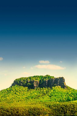 Cover page with monumental Lilienstein sandstone pillars, an iconic table like mount at sunset in the national park Saxon Switzerland by Dresden and Czechish border, Saxony, Germany. clipart