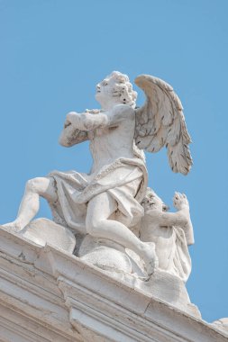 Venice, Italy - September 27, 2019: Beautiful angel with wings and light. Church Chiesa di Santa Maria Assunta, Baroque catholic church with sacred medieval art clipart