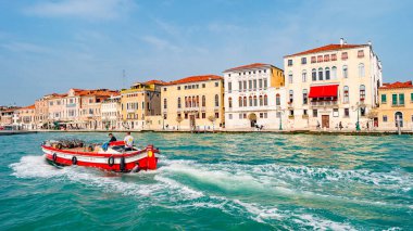 Venice, Italy  September 27, 2019 Panoramic view over busy Grand Canal with many boats, near beautiful Basilica di Santa Maria della Salute and the historical center clipart