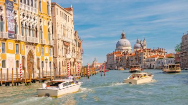 Venice, Italy  September 27, 2019 Panoramic view over busy Grand Canal with many boats, near beautiful Basilica di Santa Maria della Salute and the historical center clipart