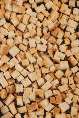 Pieces of roasted white bread in the baking tray. Close-up of delicious croutons. Top view