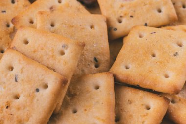 Lezzetli kare kraker yığını. Tuzlu krakerler yakın plan. Makro atış. Seçici odak.